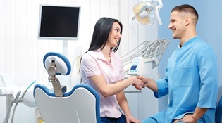 patient shaking dentist’s hand